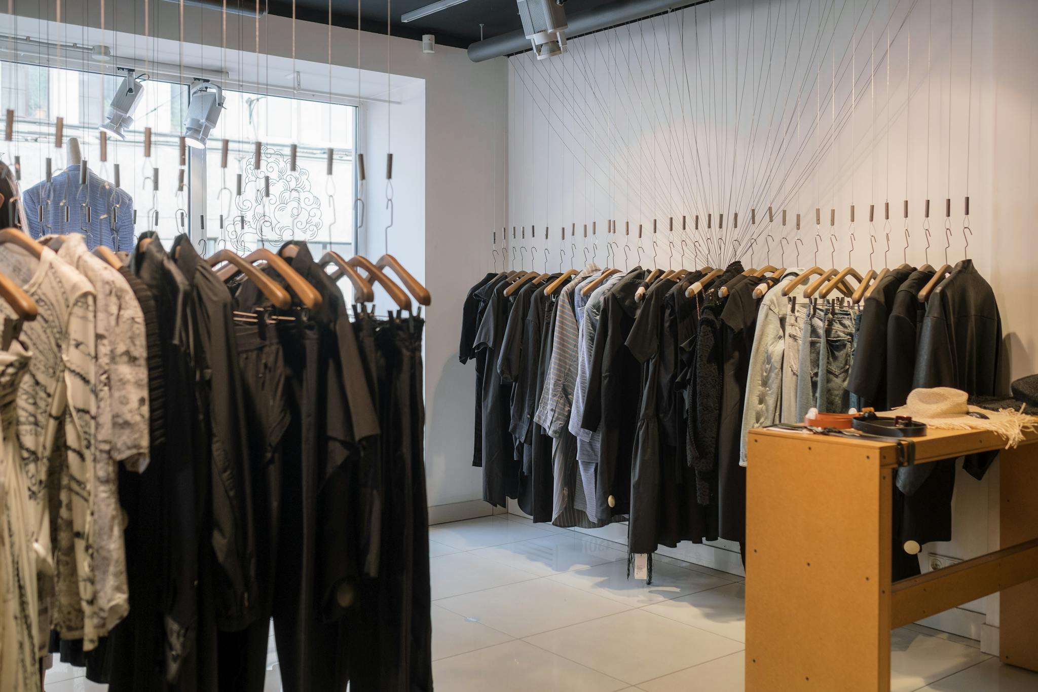 Modern clothing store showcasing a variety of garments on hangers.